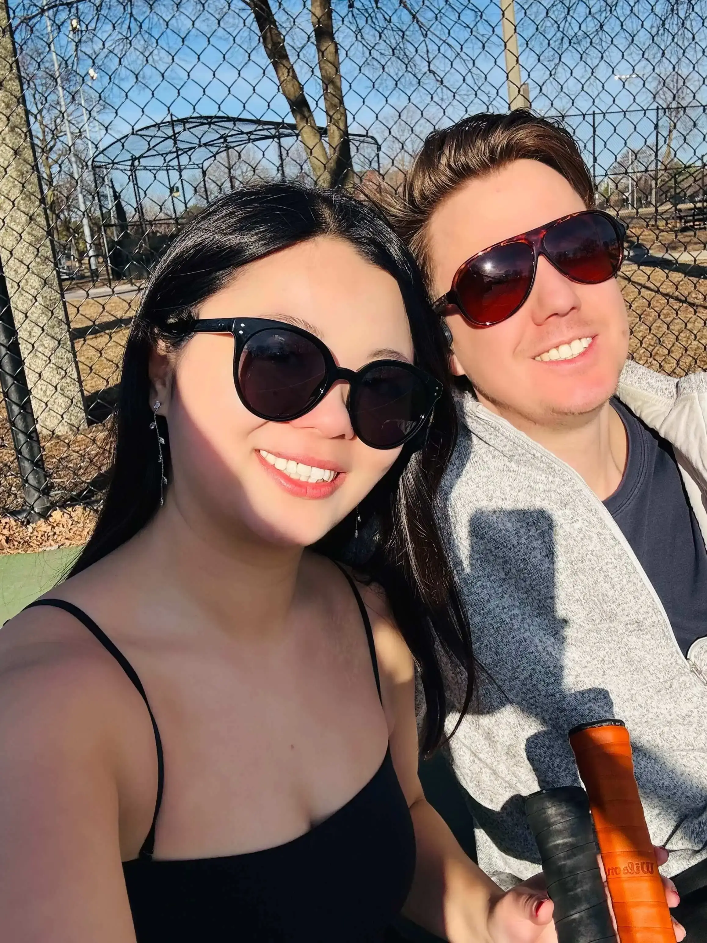 Receipt-AI founders Queenie Peng and Ian Heraty on a tennis court, smiling with rackets in hand - showing how practice and focus in fitness mirrors making effort look easy in life and business.